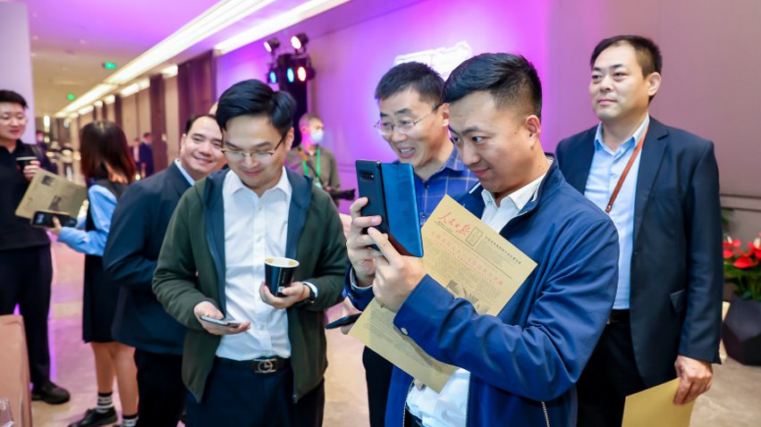 人民網(wǎng)研發(fā)推出的《人民日?qǐng)?bào)》生日?qǐng)?bào)吸引嘉賓體驗(yàn)。主辦方供圖